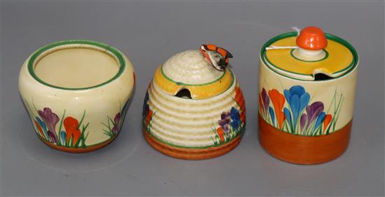 A Clarice Cliff crocus mustard with cover (repaired), preserves (cover missing) and a honey pot and cover